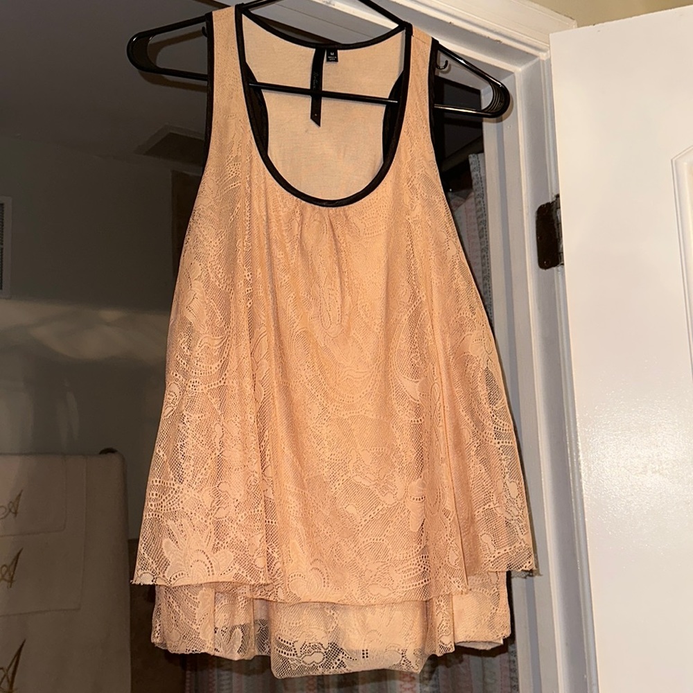 Blush pink lace top with black trim. Size Medium.